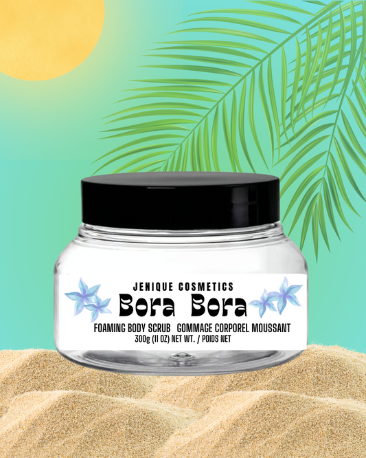 Jar of Jenique Cosmetics Bora Bora Foaming Body Scrub with a tropical leaf and sand background