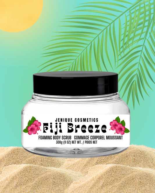 Jar of Jenique Cosmetics Fiji Breeze Foaming Body Scrub with a tropical leaf and sand background